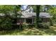 Home's brick back exterior features big windows and mature shrubs at 59 Bay Tree Ln., Pawleys Island, SC 29585