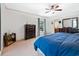 Spacious bedroom with a window, dark wood dresser, ceiling fan and neutral carpet at 59 Bay Tree Ln., Pawleys Island, SC 29585