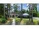 Beautiful one story home featuring a large front yard, mature trees and charming curb appeal at 59 Bay Tree Ln., Pawleys Island, SC 29585