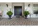 Covered front porch with brick flooring, plants and double door entry at 59 Bay Tree Ln., Pawleys Island, SC 29585