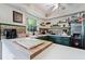 Bright kitchen featuring a tiled backsplash, white countertops and green cabinets at 59 Bay Tree Ln., Pawleys Island, SC 29585