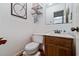 A half bathroom features an undermount sink and framed mirror at 59 Bay Tree Ln., Pawleys Island, SC 29585
