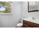Bright bathroom with a clean white vanity, tiled walls, and natural light at 602 3Rd Ave. N, Myrtle Beach, SC 29577