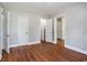 Bedroom features hardwood floors, bright walls, and open closets for ample storage at 602 3Rd Ave. N, Myrtle Beach, SC 29577
