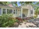 A quaint front porch features a small seating area and traditional design elements at 602 3Rd Ave. N, Myrtle Beach, SC 29577