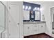 Bathroom with double sink vanity, stylish lighting, blue accent wall, and glass shower at 6029 Campanella St., Myrtle Beach, SC 29572