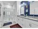 Modern bathroom featuring a glass walk-in shower and double sink vanity with a blue accent wall at 6029 Campanella St., Myrtle Beach, SC 29572