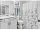 Bright bathroom with white vanity, shower with curtain, and coordinated accessories at 6029 Campanella St., Myrtle Beach, SC 29572