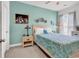 Bedroom with patterned bedding, side tables and lamps. Features a cool blue-green wall at 6029 Campanella St., Myrtle Beach, SC 29572