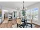 Elegant dining room with a glass-top table, chandelier, and sunlit windows showcasing the outdoor view at 6029 Campanella St., Myrtle Beach, SC 29572
