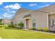 Beautiful home exterior with well-maintained lawn, garden beds and a peach colored front door at 6029 Campanella St., Myrtle Beach, SC 29572