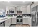 Bright kitchen showcasing white cabinets, modern appliances, sleek countertops, and a stylish backsplash at 6029 Campanella St., Myrtle Beach, SC 29572