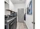 Laundry room with gray washer and dryer, white cabinets and unique mosaic backsplash at 6029 Campanella St., Myrtle Beach, SC 29572