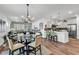 Open concept living room features a glass dining table and view into the modern kitchen with stainless appliances at 6029 Campanella St., Myrtle Beach, SC 29572