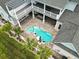 Aerial view of a beautiful house with a kidney-shaped pool, lush landscaping, and an outdoor living space at 607 Boone Hall Dr., Myrtle Beach, SC 29579
