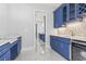Bar area features custom blue cabinetry, granite countertops and beverage refrigerator at 607 Boone Hall Dr., Myrtle Beach, SC 29579