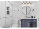 Modern bathroom featuring a glass-enclosed shower, a vanity with marble countertops and a round mirror at 607 Boone Hall Dr., Myrtle Beach, SC 29579