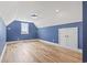 Upstairs bedroom with blue walls, hardwood floors, a ceiling fan, and natural light at 607 Boone Hall Dr., Myrtle Beach, SC 29579