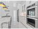 Chef's kitchen featuring professional grade stainless steel appliances, white cabinets, and granite island at 607 Boone Hall Dr., Myrtle Beach, SC 29579