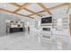 Spacious living room with marble floors, fireplace, wood beam ceiling, and open kitchen at 607 Boone Hall Dr., Myrtle Beach, SC 29579