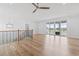 Open living room with wood flooring, fan, access to a balcony and staircase at 607 Boone Hall Dr., Myrtle Beach, SC 29579