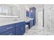 Main bathroom features dual sinks, beautiful blue cabinets and marble countertops at 607 Boone Hall Dr., Myrtle Beach, SC 29579
