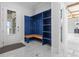 Spacious mudroom with a built-in blue storage bench and tile flooring at 607 Boone Hall Dr., Myrtle Beach, SC 29579