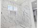 Walk-in shower with stunning marble tiling, rain shower head and a frameless glass door at 607 Boone Hall Dr., Myrtle Beach, SC 29579