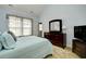 Bright bedroom features ample closet space and natural light and a chest of drawers at 6172 Catalina Dr. # 113, North Myrtle Beach, SC 29582