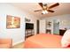 Bright bedroom with a ceiling fan, TV, and a closet with shelving for ample storage at 6172 Catalina Dr. # 113, North Myrtle Beach, SC 29582