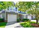 Charming two-story townhome featuring an attached garage, balcony, and well-maintained landscaping at 6172 Catalina Dr. # 113, North Myrtle Beach, SC 29582