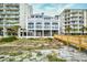 Beachfront condo featuring a wooden boardwalk to the shore, with sandy dunes and buildings at 6172 Catalina Dr. # 113, North Myrtle Beach, SC 29582