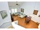 Bright living room has a sectional sofa, vaulted ceilings, and hardwood floors at 6172 Catalina Dr. # 113, North Myrtle Beach, SC 29582