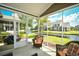 Relaxing screened patio with wicker furniture overlooking a serene pond at 6172 Catalina Dr. # 113, North Myrtle Beach, SC 29582