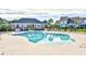 Beautifully designed swimming pool surrounded by lounge chairs and a clubhouse at 6172 Catalina Dr. # 113, North Myrtle Beach, SC 29582