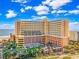 Spacious resort with a beige exterior complemented by landscaped grounds at 6900 Ocean Blvd. N # 303, Myrtle Beach, SC 29572