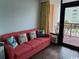Comfortable living room with a pull-out sofa and a balcony with views at 6900 Ocean Blvd. N # 303, Myrtle Beach, SC 29572