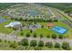 Aerial view of the community, featuring a pool, tennis courts, and scenic lake at 729 Bonita Loop, Myrtle Beach, SC 29588