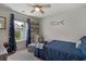 Cozy bedroom features comfortable chair with ottoman and window view, plus attractive shelving and wall decor at 729 Bonita Loop, Myrtle Beach, SC 29588