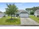 Charming home featuring a well-manicured lawn, mature tree, and a two-car garage at 729 Bonita Loop, Myrtle Beach, SC 29588
