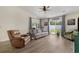 The bright living room features wood floors, comfortable seating, and access to the backyard at 729 Bonita Loop, Myrtle Beach, SC 29588