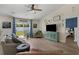 Bright living room features wood floors, ceiling fan, and sliding glass doors to the backyard at 729 Bonita Loop, Myrtle Beach, SC 29588