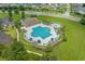 Aerial view of community pool with ample seating, umbrellas, and surrounding green space at 729 Bonita Loop, Myrtle Beach, SC 29588