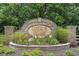Stone sign for Cameron Village, a Beazer Homes Community, surrounded by lush landscaping at 729 Bonita Loop, Myrtle Beach, SC 29588