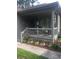 Charming front porch with a seating area surrounded by colorful flowers and landscaping at 814 James Landing Ct., Murrells Inlet, SC 29576