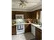 A traditionally decorated kitchen featuring stained cabinets and white appliances at 814 James Landing Ct., Murrells Inlet, SC 29576