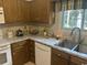 This is a charming kitchen with updated counters and stained wood cabinets at 814 James Landing Ct., Murrells Inlet, SC 29576