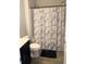 Full bathroom with a marble shower curtain, modern vanity, and sleek tile flooring at 821 Falkirk St., Myrtle Beach, SC 29579