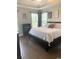 Comfortable bedroom with hardwood floors, a tray ceiling, and natural light from the windows at 821 Falkirk St., Myrtle Beach, SC 29579