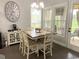 Cozy breakfast nook with a tiled table, seating for six, and natural light from several windows at 821 Falkirk St., Myrtle Beach, SC 29579